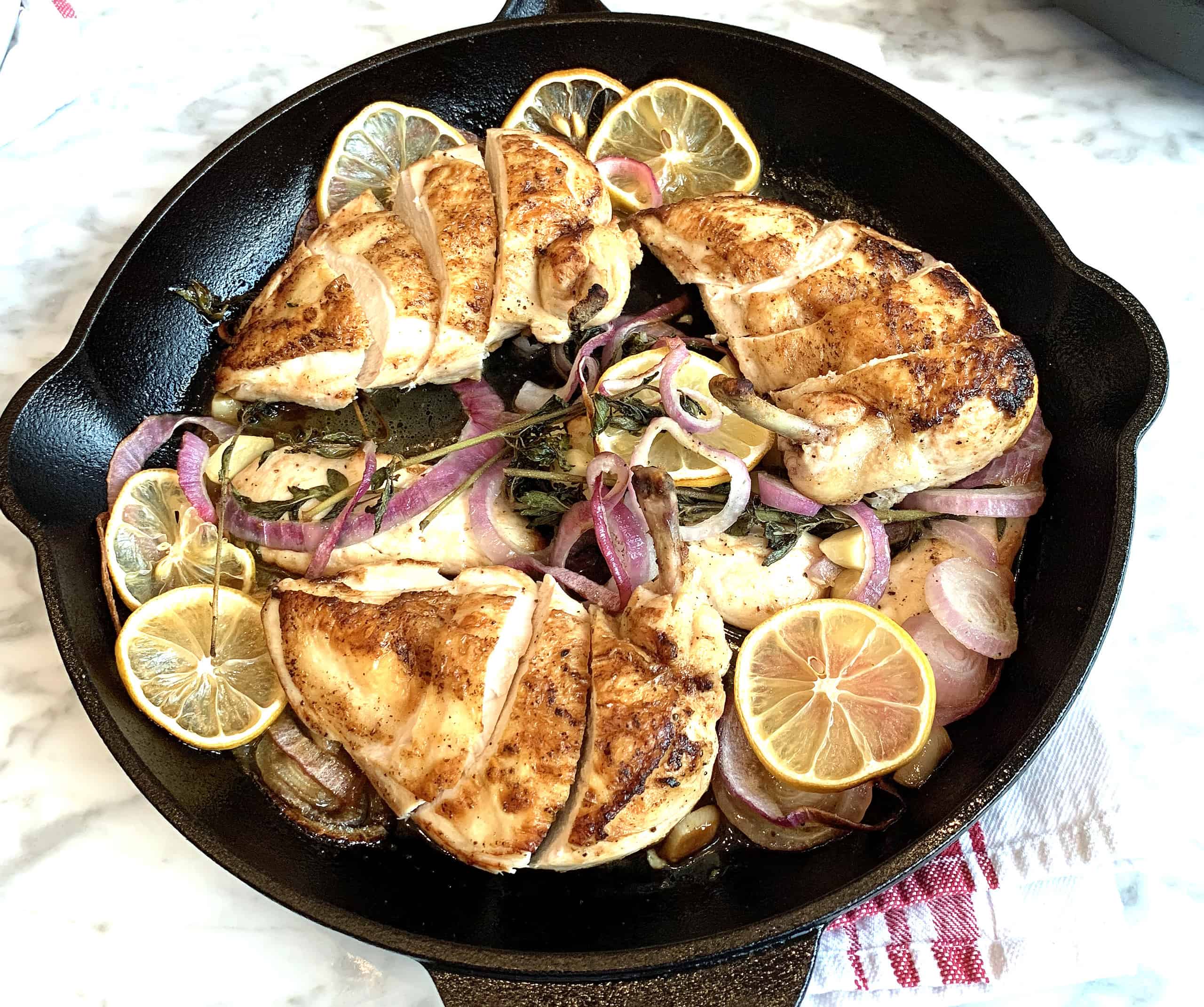 Baked chicken over sautéed onions, herbs, and garlic-lemon