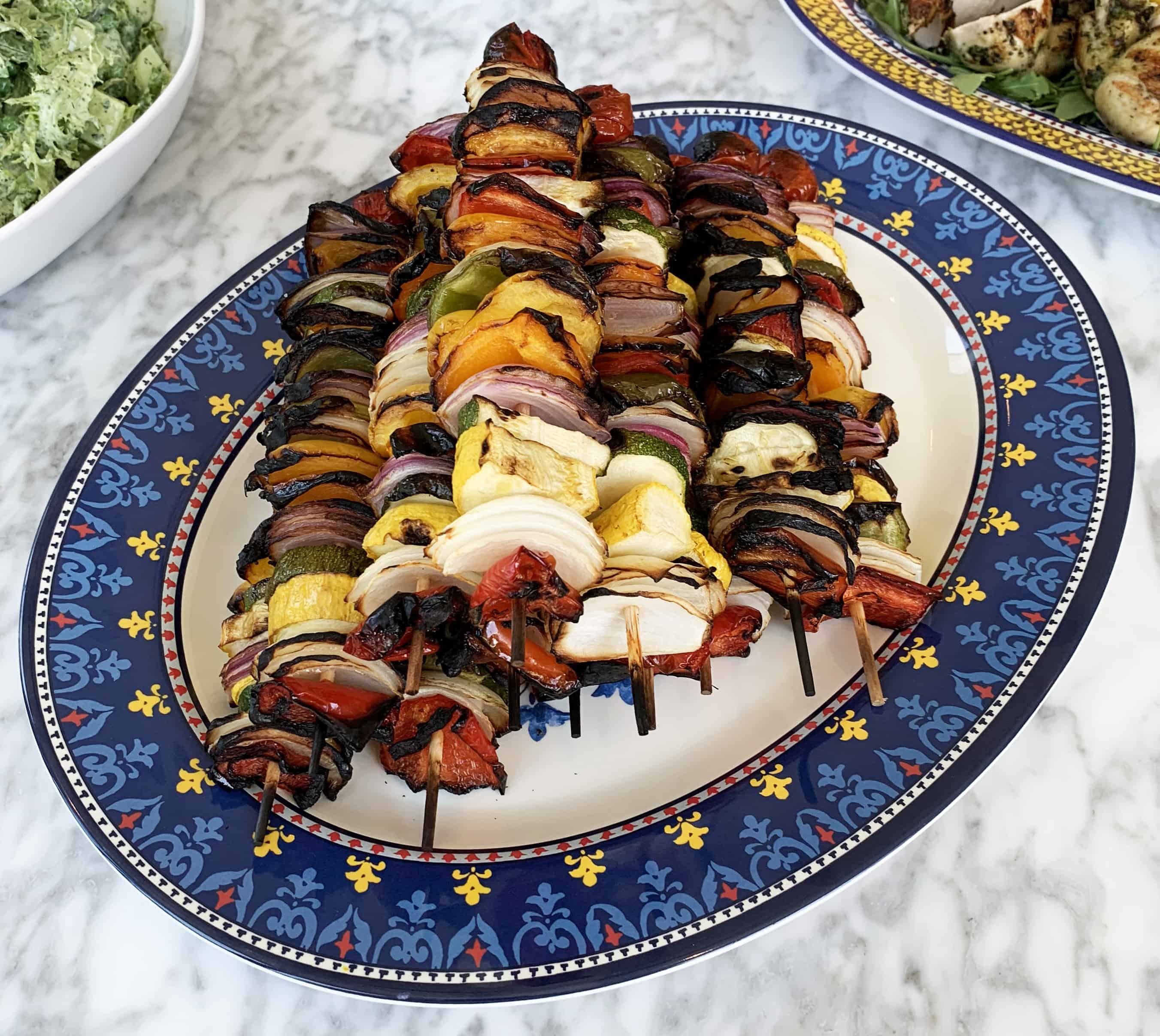 Grilled veggie kabobs with onions, bell peppers, squash, tomatoes, and zucchini