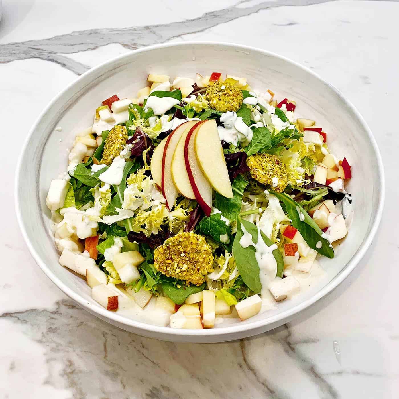 Mixed greens spinach and apple salad with herb dressing