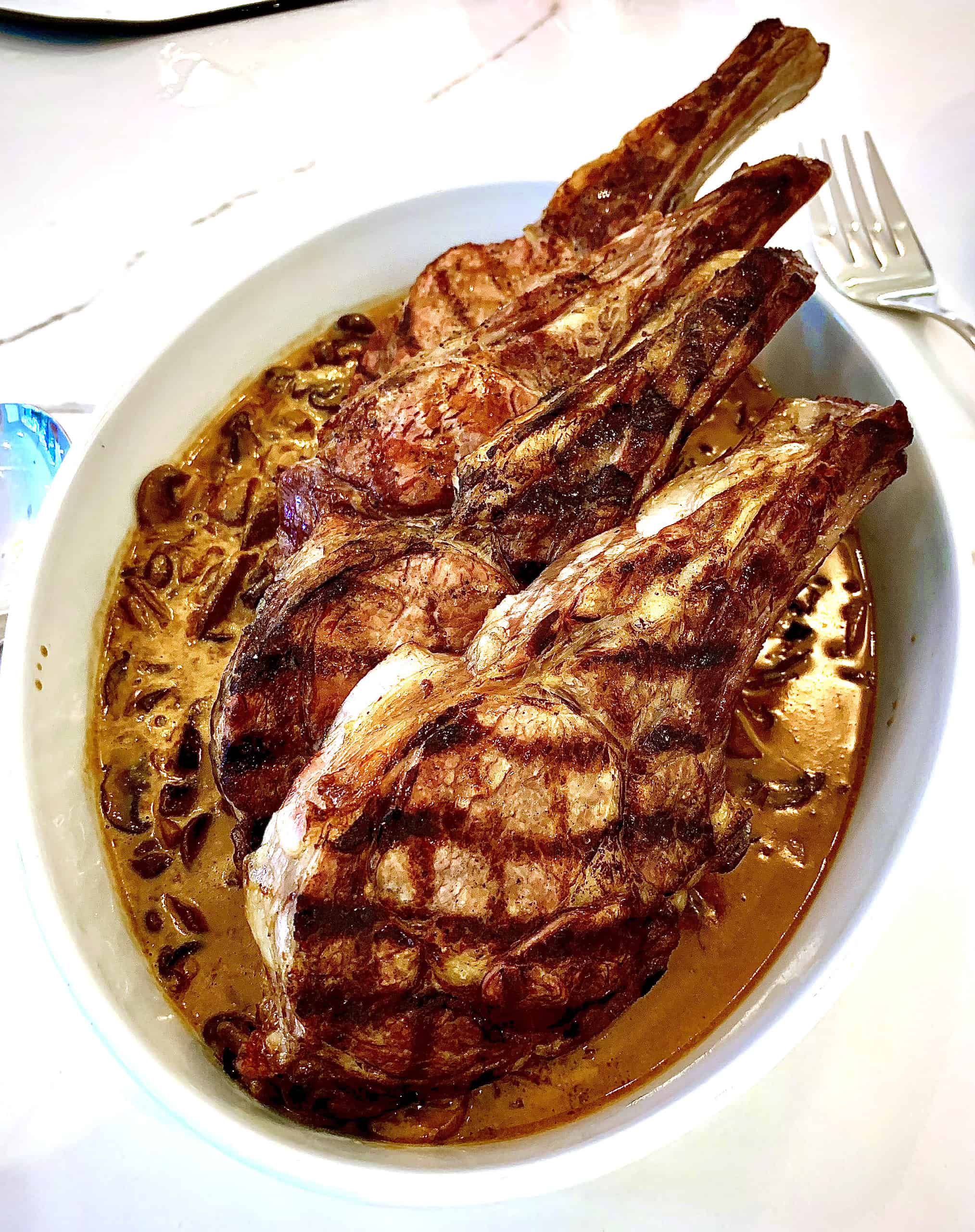 Grilled pork chops over butter and mushrooms