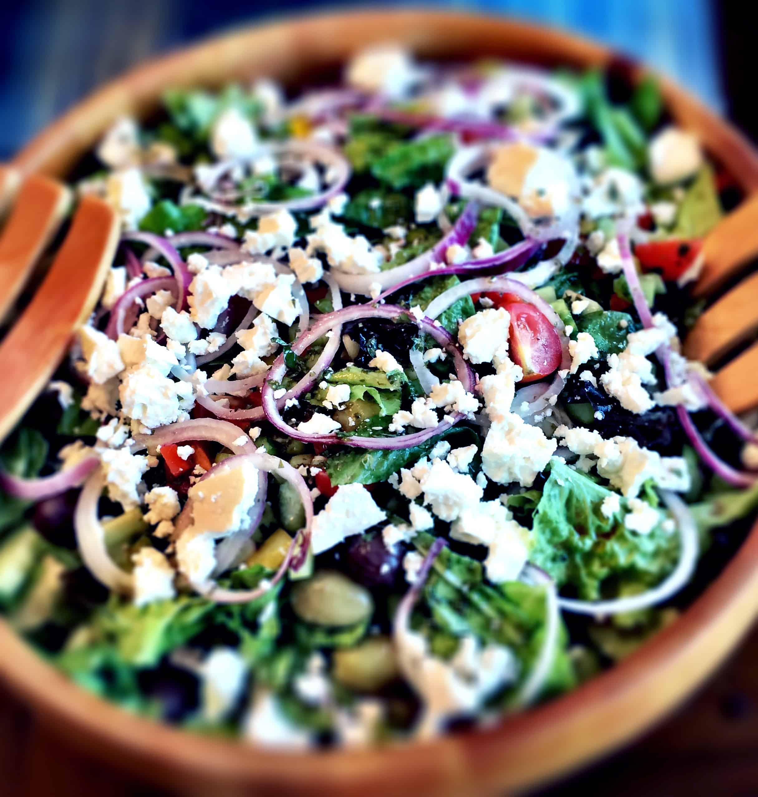 Romaine lettuce, red onion, feta, tomato, and olives salad with vinaigrette