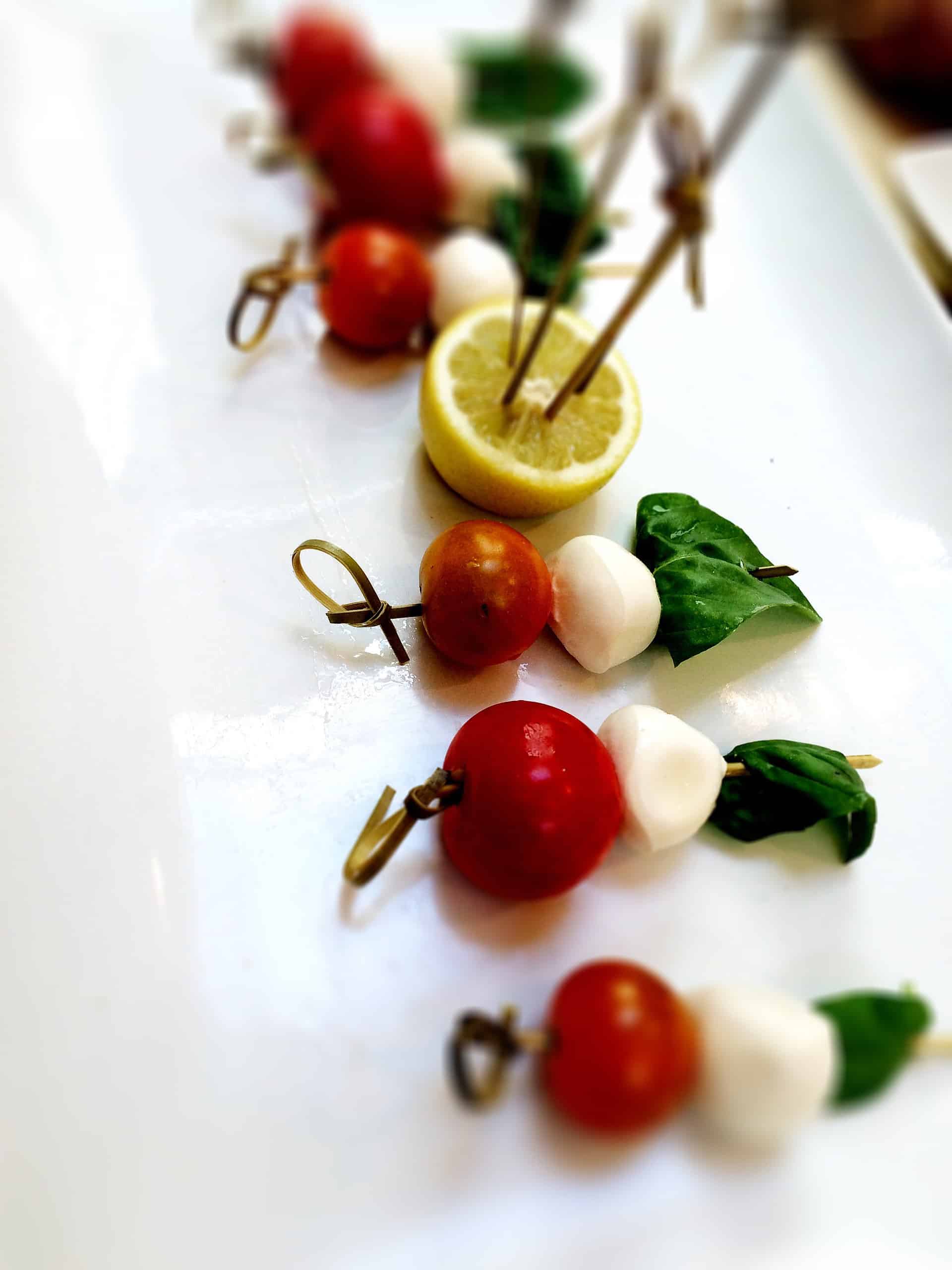 Hors d’oeuvre of cherry tomatoes, fresh mozzarella, and basil
