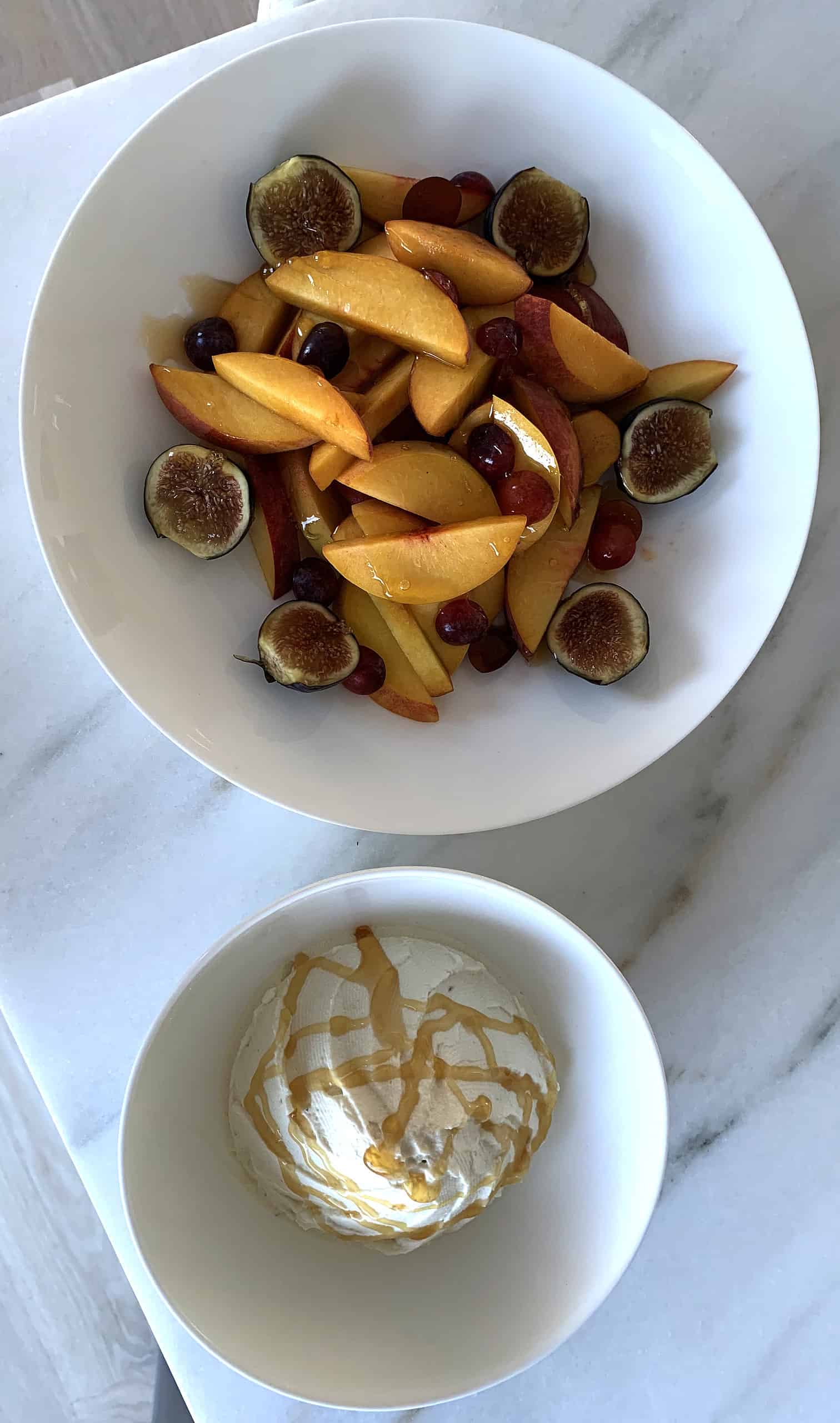 Peaches, grapes, passion fruit with a side of whipped cream and honey drizzle